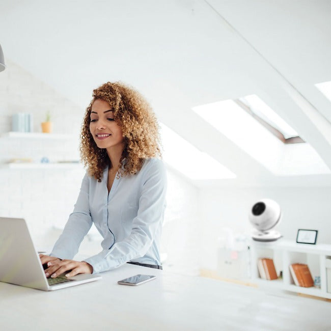 Woman works with pureFlow QT7 bladeless fan in background